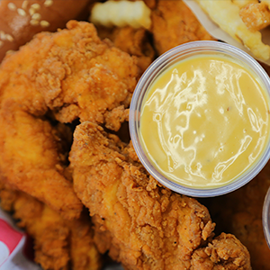 Chicken tenders, honey mustard sauce and fries